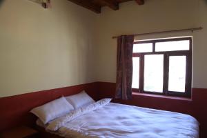 A bed or beds in a room at Himalayan Paradise