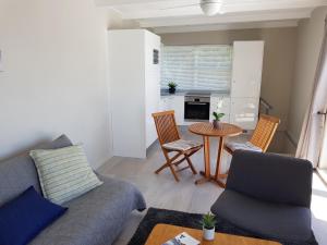 a living room with a couch and a table at Camps Bay Cosy Accommodation in Cape Town