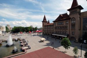 a building with a fountain in the middle of a plaza at Lira Hotel in Saratov