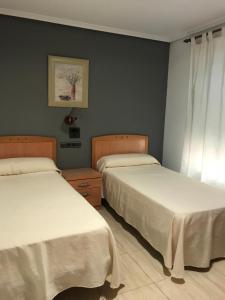 Postel nebo postele na pokoji v ubytování Hostal Meseguer