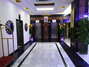 a lobby of a hotel with flowers on the walls at Al Mabila Hotel in Seeb