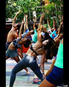 a group of women doing a yoga pose at Lagarto Na Banana Hostel in Pipa