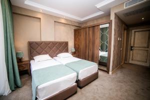 Postel nebo postele na pokoji v ubytování Boutique Hotel Mimino