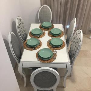 a white table with green plates on it at Ap. Palacete Marqués d la Vega in Antequera