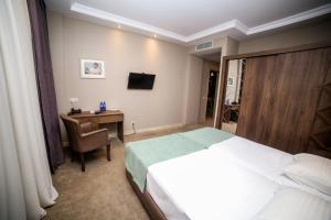 Postel nebo postele na pokoji v ubytování Boutique Hotel Mimino