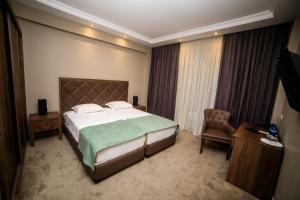 Postel nebo postele na pokoji v ubytování Boutique Hotel Mimino