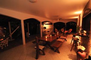 een woonkamer met een houten tafel en stoelen bij Casa Atalaia in Pipa