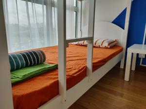 a bunk bed in a room with a window at SkyBed Over The Sky Hostel @Regalia Suites & Residences KL in Kuala Lumpur