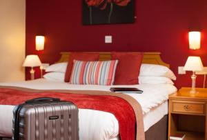 a hotel room with a bed and a lamp at Adelphi Portrush in Portrush