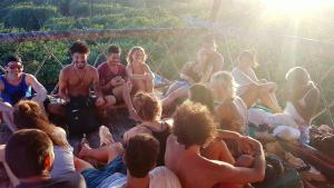 a group of people sitting in a circle on a raft at Lagarto Na Banana Hostel in Pipa