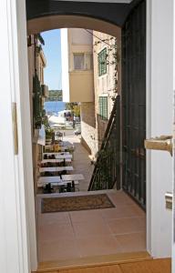 a view of a balcony with tables and chairs at Swan City Apartment & Room in Šibenik