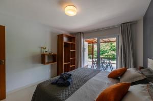 a bedroom with a bed with a camera on it at Condominio Luna Rossa in Morro de São Paulo