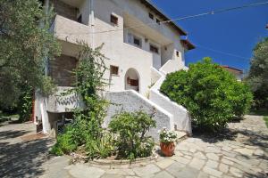 a white building with plants in front of it at Villa Angela in Vourvourou
