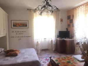 a bedroom with a bed and a large window at La Casina Di Jessica in Aulla