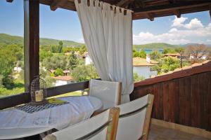 a table and chairs on a balcony with a view at Villa Angela in Vourvourou