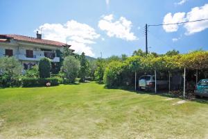 a yard with a house and a car parked at Villa Angela in Vourvourou