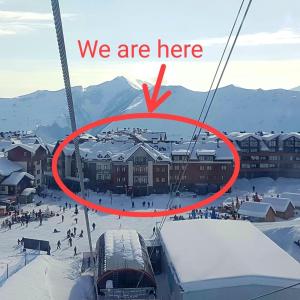 a group of people on a ski lift in the snow at Zen Apartments Gudauri in Gudauri