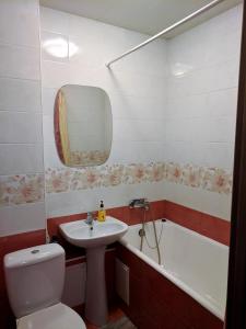 a bathroom with a sink and a toilet and a tub at Dream Town Apartment in Kyiv