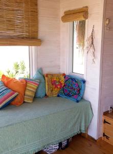 a room with pillows on a bench in a window at Casa Papaya in Punta Del Diablo