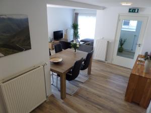 a dining room and living room with a table and chairs at B&B Het Rijkzicht in Groesbeek