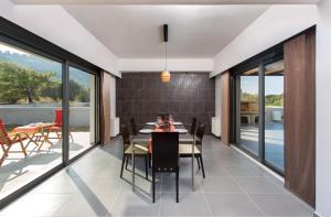 a dining room with a table and chairs at Filerimos Garden Villa in Ialyssos
