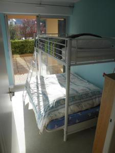 a bunk bed in a room with a window at Appartement T3 - 4 personnes - Face Océan - Thalasso in Pornichet