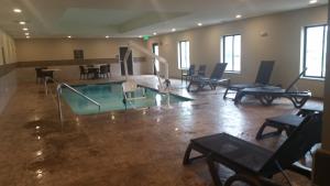 a large room with a pool and tables and chairs at Comfort Inn White House in White House