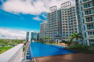 a view of a river in front of a building at Mactan Newtown Condo with Pool access in Mactan