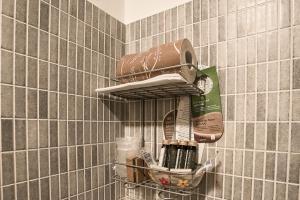 a shelf in a tiled wall with some kitchen items at Hotel Milano Navigli in Milan