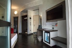 a hotel room with a television and a living room at Hotel Milano Navigli in Milan