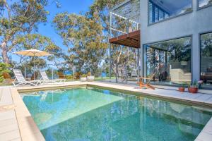 a swimming pool in the backyard of a house at The Edgewater on Greville in Sanctuary Point