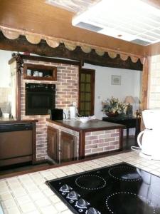 a kitchen with a stove top oven in a room at Château Dudon in Barsac