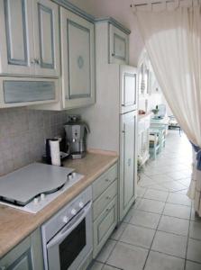 a kitchen with white cabinets and a counter top at villino Bougainville in Palau