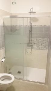 a bathroom with a glass shower with a toilet at B&B Happy Guest in Caprino Veronese +21 photos