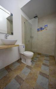 a bathroom with a toilet and a sink at Casa Relax - Adults Only in Taganga