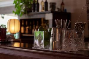 a bar with several glasses on a counter at Hotel Simius Playa in Villasimius
