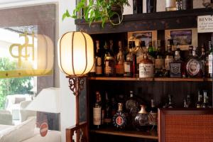 a bar with a lot of bottles of alcohol at Hotel Simius Playa in Villasimius