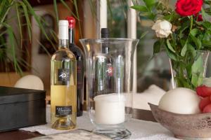 a table with two bottles of wine and a vase with eggs at Hotel Simius Playa in Villasimius