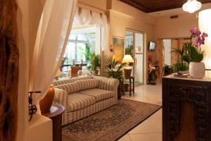 a living room with a couch and a table at Hotel Simius Playa in Villasimius