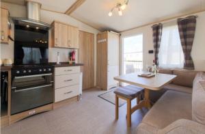 a kitchen and living room with a couch and a table at Blenheim, Padstow in Padstow