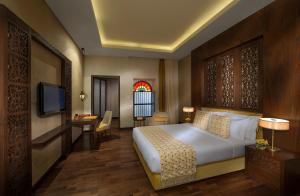 Tempat tidur dalam kamar di Souq Waqif Boutique Hotels - Tivoli