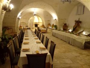 a long dining room with long tables and chairs at Agriturismo Tenuta Mazzetta in Mesagne