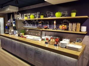 a kitchen with a counter with food on it at ibis budget Koeln Leverkusen City in Leverkusen