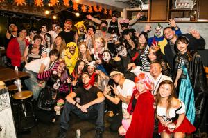 a group of people dressed in costumes posing for a picture at Wise Owl Hostels Shibuya in Tokyo