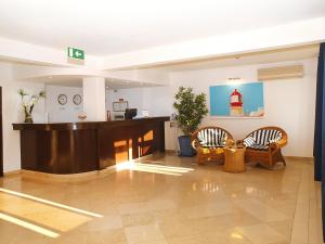 a lobby with two chairs and a reception desk at Portimão Center Hotel in Portimão