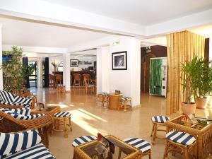 a lobby with chairs and tables and a restaurant at Portimão Center Hotel in Portimão