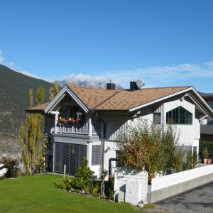 a white house with a balcony with flowers on it at Haus Susi in Imsterberg