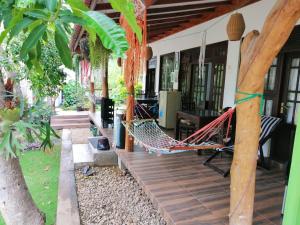 a hammock on the porch of a house at Villa Eden Paradise in Ella