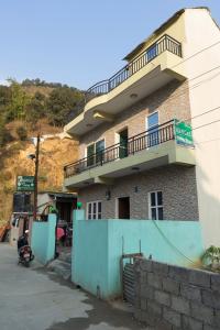 a building with a balcony on top of it at Mangal homestay in Pokhara