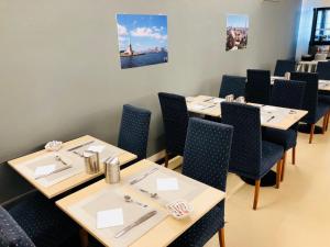a row of tables and chairs in a restaurant at B&B Hotel Roy in Silea
